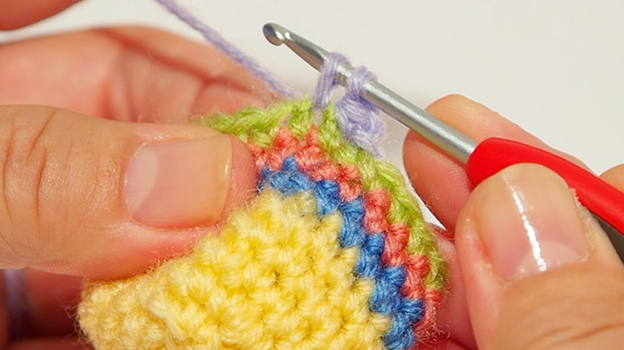 Pull the wool through. Then pull the wool through the next stitch.